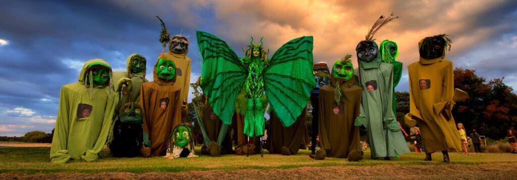 Photo of people dressed in fabric bug or creature outfits. Image: WildHoney - Walking with Giants, Photographer : Rebecca Hosking