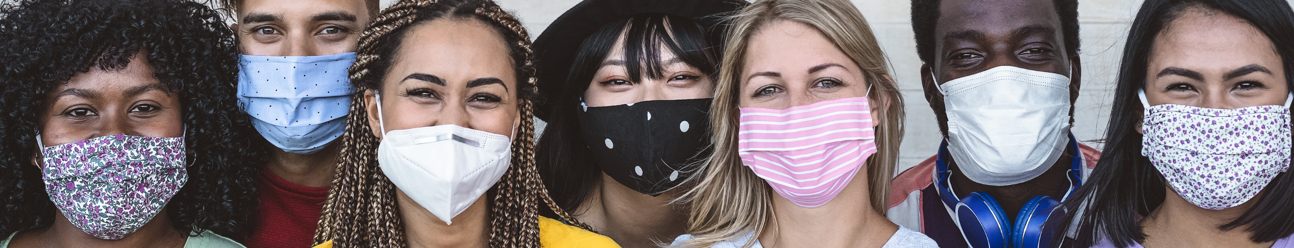 People of different races wearing protective face masks.